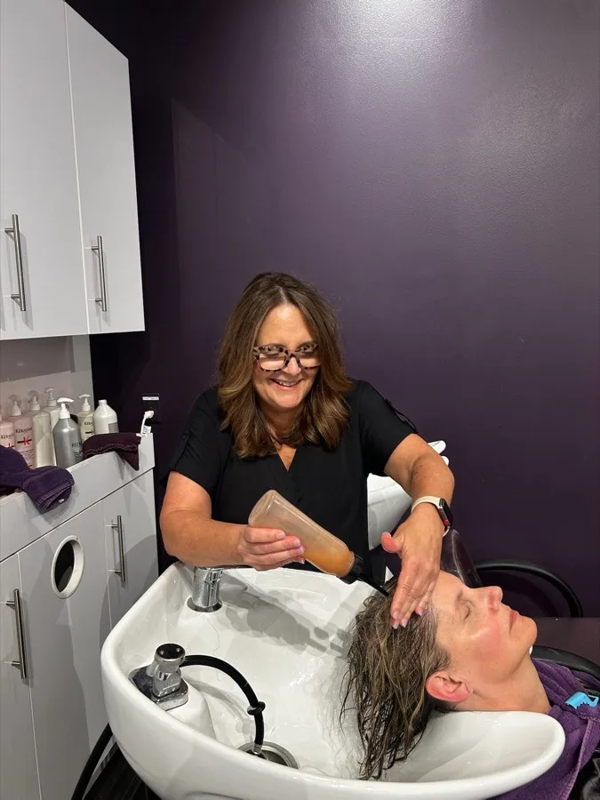 Guest relaxing during a shampoo service at Charles David Salon