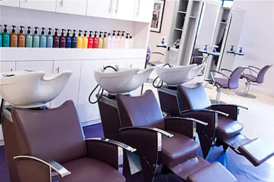 Backwash chairs and Redken color wall inside a Charles David Salon location